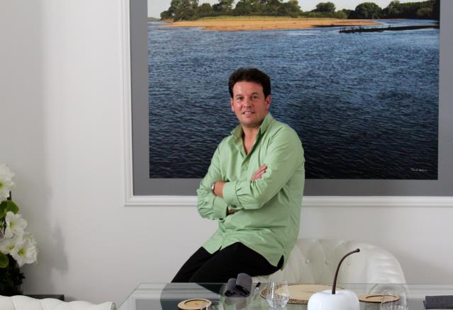 Le chef Pascal Favre d'Anne dans son nouveau « loft culinaire », devant une photo de l'île du Hardas : une île sur la Loire, qu'il vient d'acquérir et où il compte faire pousser fruits et légumes.