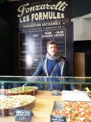 L'un des associés de Fonzarelli, Igor Couston, devant le comptoir de pizzas vendues al taglio ('à...