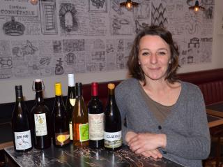 Emilie dans son bistrot resto convivial, sur le mur les dessins d'un artiste connu