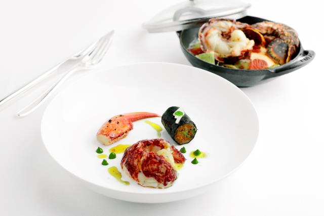 Demi-homard bleu en vapeur de sel aux aromates, tartare de pattes et julienne de légumes en cannelloni vinaigrette épicée.